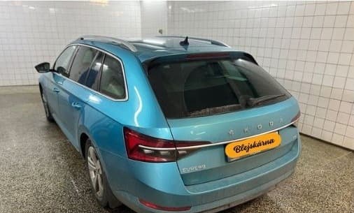 Zadní část modré Škody před ruční péčí